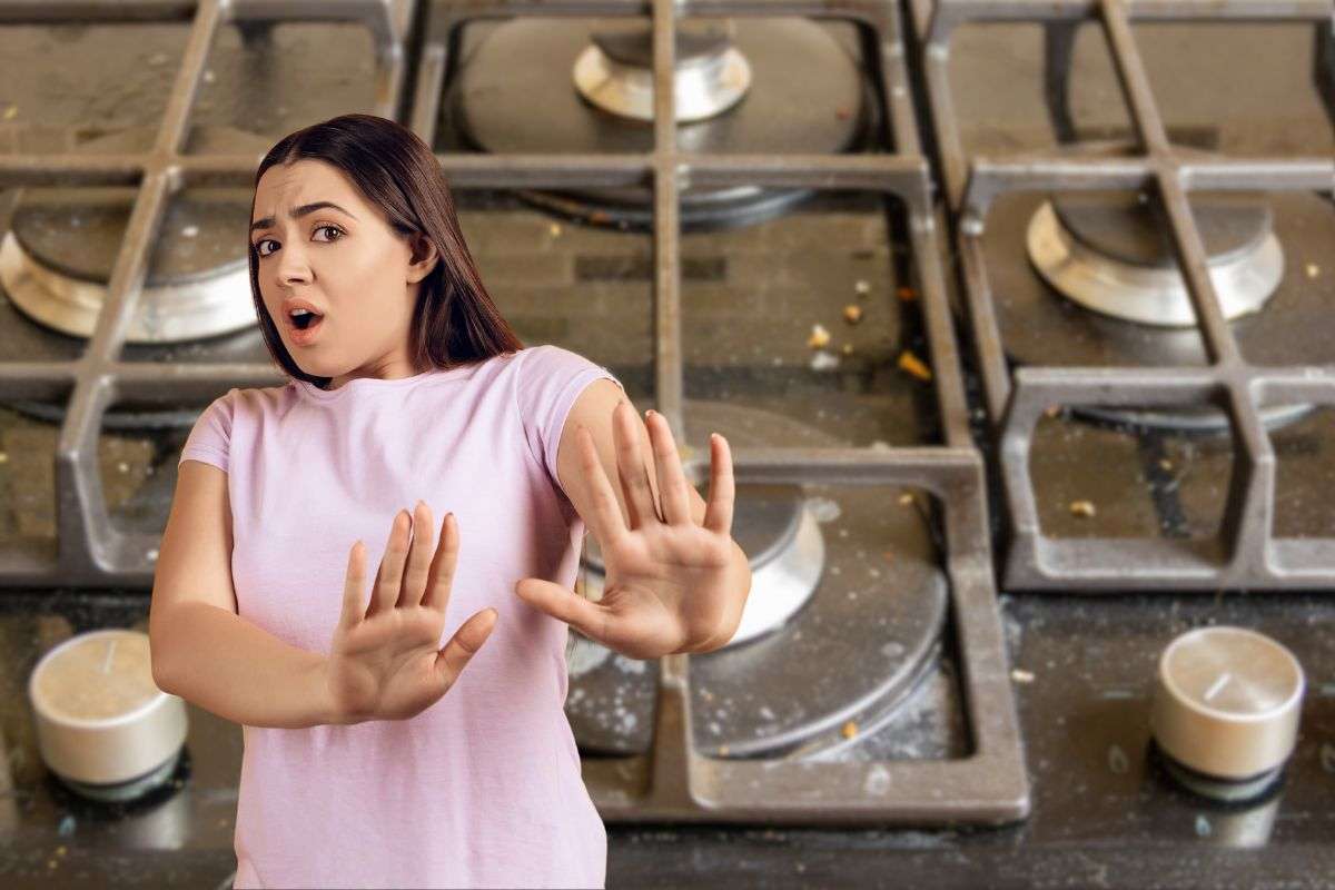donna disgustata e piano cottura sporco